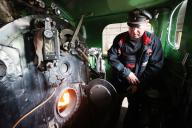 19 May 2024, Thuringia, Wintersdorf: Stoker Dirk Müller prepares the "Wilde Hilde" steam locomotive of the Meuselwitz coal railroad for its journey. The historic vehicle, built in 1944, once again runs regularly from Meuselwitz to Regis-Breitungen. Photo: Bodo Schackow/dpa