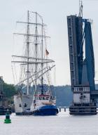 19 May 2024, Mecklenburg-Western Pomerania, Stralsund: The sailing ship "Gorch Fock I" is towed by tugboats from the Volkswerft shipyard through the Ziegelgraben and Rügen bridges into the city harbor. After extensive repairs to the 90-year-old sailing ship at the shipyard, the ship will be moored in the city