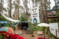 19 May 2024, Brandenburg, Grünheide: A banner with the inscription "Water is a human right" hangs between the tree houses of the protest camp of the "Stop Tesla" initiative near the Tesla plant. Photo: Fabian Sommer/dpa