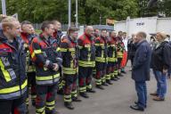 18 May 2024, Saarland, Saarbrücken: Federal Chancellor Olaf Scholz (2nd from right, SPD) and Anke Rehlinger (right, SPD), Minister President of the Saarland, visit the Saarbrücken stadium to see the emergency services deployed to help with the Saar floods. Photo: Helmut Fricke/dpa