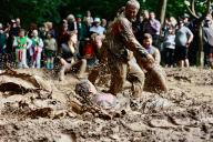 20 May 2024, Saxony-Anhalt, Hergisdorf: Participants jump into a mud hole at the Dirty Pig Festival 2024 in Hergisdorf on the festival grounds in the wild. At the forest party there, the actual Dirty Pig Festival, winter is symbolically chased away. To do this, the men jump into a mud hole. Photo: Matthias Bein/dpa
