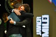 17 May 2024, Spain, Madrid: Javier Milei (r), Argentinian President, hugs Santiago Abascal, Chairman of Vox, at the "Viva 24" event organized by the right-wing populist party Vox. Photo: Cezaro De Luca/dpa