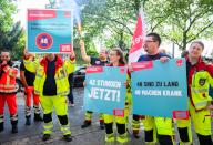 21 May 2024, Lower Saxony, Hanover: Employees in the municipal rescue service protest against long working hours in front of the offices of the Lower Saxony Municipal Employers