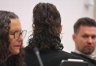 21 May 2024, Bavaria, Memmingen: A 34-year-old woman (M) is sitting in the dock between her lawyers Anja Mack and Alexander Hamburg in a courtroom at the regional court. Because she is alleged to have killed her husband treacherously and out of greed by setting him on fire, a 34-year-old woman will have to answer for murder at Memmingen Regional Court from Tuesday (9.00 a.m.). According to the indictment, the 38-year-old died in May last year from smoke inhalation in the apartment the couple shared in Memmingen. Photo: Karl-Josef Hildenbrand/dpa