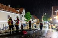 21 May 2024, Bavaria, Kastl: Firefighters work on the edge of the flooding. Masses of water flow over the market square in the municipality of Kastl after heavy rain from the Lauterach river. Cars floated across the streets, people were trapped in their homes. Photo: Daniel Karmann/dpa