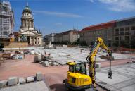 22 May 2024, Berlin: Large parts of the Gendarmenmarkt are covered with new stone slabs against the backdrop of the French Cathedral. During the renovation and modernization work, the historic square in the center of Berlin will be given a new underground infrastructure and a modern rainwater management system. Once the civil engineering work is complete, new natural stone paving will be laid on the square. Photo: Soeren Stache/dpa