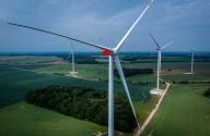 22 May 2024, Mecklenburg-Western Pomerania, Rieps: Wind turbines turning at the new Rieps wind farm. (Aerial view with a drone). The pilot project of Mecklenburg-Vorpommern Energie (mve) consists of six Nordex turbines with a total output of 34.2 megawatts. mve is a joint venture between mea Energieagentur GmbH, a subsidiary of energy supplier WEMAG, and Energieverbund Nord. Photo: Jens Büttner/dpa