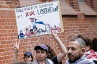 22 May 2024, Berlin: A participant holds a sign with the text "Generation after Generation until total Liberation!" ("Generation after generation until total liberation!") at the demonstration "School strike for Palestine" in front of the Ernst-Abbe-Gynasium in Neukölln. Photo: Carsten Koall/dpa