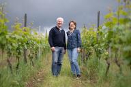 PRODUCTION - 22 May 2024, Hesse, Hattenheim: Winegrowers Urban Kaufmann (l) and Eva Raps stand between the vines of their vineyard outside Hattenheim in the Rheingau. Photo: Boris Roessler/dpa