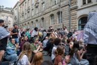 22 May 2024, Berlin: Pro-Palestinian demonstrators sit and stand in front of the Institute of Social Sciences at Humboldt University. Activists have occupied rooms at Berlin