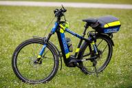 22 May 2024, Bavaria, Nuremberg: A pedelec from the Middle Franconia traffic police bicycle group is parked in a meadow. Photo: Daniel Karmann/dpa