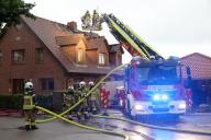 22 May 2024, Schleswig-Holstein, Hamberge: Firefighters are busy extinguishing a fire at a house in the Stormarn district which, according to the fire department, caught fire due to a lightning strike during a storm. Photo: Bodo Marks/dpa