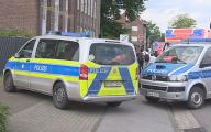 23 May 2024, North Rhine-Westphalia, Goch: Police and emergency vehicles are on the street. A man is killed and another man suffers life-threatening injuries during an argument in a temporary workers