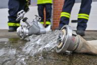23 May 2024, Brandenburg, Prenzlau: Water flows from a fire department hose. Photo: Patrick Pleul/dpa