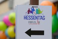 24 May 2024, Hesse, Fritzlar: The logo of the 61st Hessentag can be seen in front of balloons. Under the motto "A city full of life", guests can expect a diverse range of traditional and progressive events at Germany