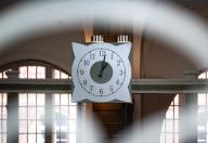 24 May 2024, Berlin: A new court clock hangs in the entrance hall of the court in Littenstraße. The new clock is the successor to a historic court clock that was destroyed during the Second World War. Photo: Monika Skolimowska/dpa