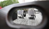 24 May 2024, Baden-Württemberg, Stuttgart: Chairs in an outdoor restaurant are folded up in rainy weather. Photo: Bernd Weißbrod/dpa