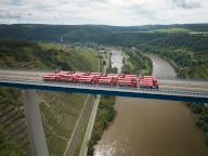 26 May 2024, Rhineland-Palatinate, Winningen: Trucks with a total weight of 960 tons stand on the Moselle valley bridge near Winningen during a load test (aerial photo taken with a drone). For this reason, the A61 bridge is fully closed from the morning until late afternoon. The dilapidated bridge is to be renovated over the next few years. Photo: Thomas Frey/dpa