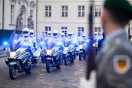 26 May 2024, Berlin: The Berlin police motorcycle squadron drives up to Bellevue Palace as an honorary escort for the French President