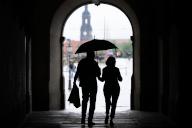 28 May 2024, Saxony, Dresden: Passers-by are silhouetted under St. George