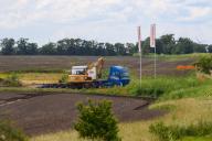 28 May 2024, Saxony-Anhalt, Magdeburg: Construction machinery stands at an access road to a fallow field. Intel wants to build a chip factory there. As part of the approval process for Intel