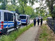 30 May 2024, Brandenburg, Potsdam: Police officers walk along the cordoned-off crime scene in Potsdam