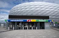 30 May 2024, Bavaria, Munich: The lettering "UEFAEURO2024 - MUNICH" can be seen at an entrance to the Munich Football Arena. The opening match of the European Football Championship will take place in the arena on June 14, 2024. The European Football Championship will take place from June 14 to July 14. Photo: Sven Hoppe/dpa
