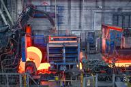 30 May 2024, Brandenburg, Eisenhüttenstadt: Glowing flat steel is wound into a coil in the hot rolling mill of ArcelorMittal Eisenhüttenstadt GmbH. In the afternoon, Federal Economics Minister Habeck (Greens) is scheduled to hand over a grant for climate-neutral steel production to ArcelorMittal. The joint decarbonization project of the Eisenhüttenstadt and Bremen sites is of outstanding importance for the future of ArcelorMittal