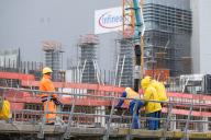 30 May 2024, Saxony, Dresden: Construction workers stand on the building site of Infineon