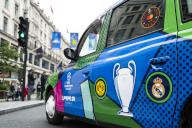 30 May 2024, Great Britain, London: A London Taxi with the logos of Borussia Dortmund and Real Madrid is parked at the Champions Festival in Regent Street. The Champions League final between Dortmund and Real Madrid will take place at Wembley Stadium on Saturday, June 1. Photo: Tom Weller/dpa