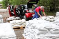 31 May 2024, Saxony, Plauen: Margit Streubel (back) and Günter Jentsch load sandbags into their car. Citizens in Plauen were able to pick up up to 20 sandbags on Friday in preparation for the predicted heavy rain. Photo: Katrin Mädler/dpa-Zentralbild/dpa - ATTENTION: Only for editorial use in connection with current reporting and only with full reference to the above credit