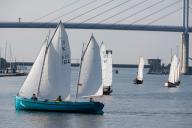 01 June 2024, Mecklenburg-Western Pomerania, Stralsund: Sailing boats sail in the harbor in front of the Rügen Bridge. The boats start the "Rund Hiddensee" race. The Harbour Days and the Stralsund Sailing Week in Stralsund are expected to attract many visitors to the city until Sunday evening. Photo: Stefan Sauer/dpa