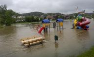 01 June 2024, Bavaria, Kirchhaslach: A playground is flooded by the Haselbach stream. After the heavy rainfall of the last few days, there is flooding in the region. Photo: Stefan Puchner/dpa