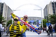 01 June 2024, Great Britain, London: Soccer: Champions League, Borussia Dortmund - Real Madrid, knockout round, final, Wembley Stadium. Two Dortmund fans with a BVB fan scarf stand in front of Wembley Stadium. Photo: Tom Weller/dpa