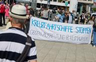 01 June 2024, Schleswig-Holstein, Kiel: Demonstrators hold a banner reading "Stop cruise ships. Against exploitation & climate change". The "Initiative against cruise ships in Kiel and elsewhere" called for a demonstration "on water and on land". Photo: Georg Wendt\/dpa