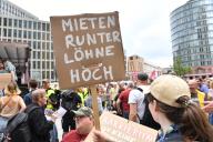 01 June 2024, Berlin: "Rents down, wages up" is written on a poster during a demonstration against high rents. Numerous people responded to the call for a rent demonstration at Potsdamer Platz. On placards and banners, they demanded a rent cap and the expropriation of housing associations, among other things. Photo: Paul Zinken/dpa