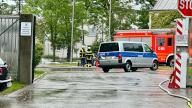 01 June 2024, Bavaria, Memmingen: Emergency vehicles from the police and fire department are parked on the grounds of the prison in Memmingen. Around 100 prisoners were brought to safety due to flooding. Photo: Davor Knappmeyer/dpa