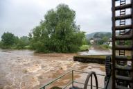 02 June 2024, Bavaria, Gleusdorf: Masses of water rush through the weir of the Gleusdorf mill (Haßberge district, Lower Franconia). The Itzgrund is flooded. The Schenkenau gauge has reached level 3. Roads are flooded and the flooded area reaches as far as the first houses. Photo: Pia Bayer/dpa