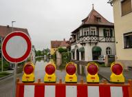 02 June 2024, Bavaria, Wertingen: A barrier stands in front of a flooded street. After the heavy rainfall of the last few days, flooding occurred and the residents of Wertingen were asked to move to higher floors. Photo: Stefan Puchner/dpa