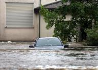 02 June 2024, Bavaria, Offingen: A car is standing in the floodwater of the Mindel in a residential area. Photo: Karl-Josef Hildenbrand/dpa