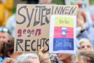 02 June 2024, Schleswig-Holstein, Westerland (sylt): Participants hold up cardboard signs at a rally, including a sign with the words "Sylt residents against the right". Following the racism scandal on Sylt, several groups had called for a demonstration. Photo: Bodo Marks/dpa