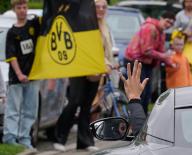 02 June 2024, North Rhine-Westphalia, Dortmund: Soccer: Champions League, after the final between Borussia Dortmund and Real Madrid. Mats Hummels waves to the fans from the car as he leaves the training ground. Photo: Bernd Thissen/dpa
