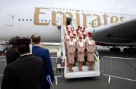 03 June 2024, Brandenburg, Schönefeld: A crew from Emirates airline has its photo taken on the steps in front of an Airbus A380-800 two days before the start of the International Aerospace Exhibition at Berlin Brandenburg Airport (BER). Around 600 exhibitors from 30 countries will be showcasing numerous aircraft and aerospace innovations at the "Innovation Fair of the Aerospace Industry", which takes place from 5 to 9 June 2024. Photo: Bernd von Jutrczenka/dpa