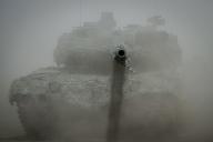 26 June 2023, Lithuania, Vilnius: A German Army Leopard 2 main battle tank is seen in the dust during NATO