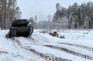 15 December 2023, Lithuania, Rukla: A Leopard 2 A6 tank drives at the Lithuanian Gaiziunai military training area, around 90 kilometers northwest of the capital Vilnius. The first Leopard 2 tanks delivered to Ukraine and damaged in the battle against Russia have been repaired in Lithuania. The repaired battle tanks will soon return to the battlefield in the Baltic EU and NATO country. Photo: Alexander Welscher/dpa