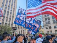 An US flag and one supporting former President Donald Trump for the 2024 elections stand out among the people gathered near the Manhattan Criminal Court this Monday, in New York, USA, 15 April 2024. Hundreds of police officers, journalists from around the world and around twenty followers of former President Donald Trump (2017-2021) gathered this Monday near the Manhattan Criminal Court with the same objective, to see first-hand a historical event: the first time in the US that a former president faces a criminal trial. EFE/ Sarah Yanez-richards