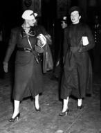Katharine Hepburn (r) and her secretary Laura Harding (l), arrive at Penn Station, after she obtained a divorce from Ludlow Smith in Mexico. New York, New York, May 3, 1934. Courtesy CSU Archives/Everett Collection.