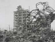 News photographer (lower left) documenting ruins in Hiroshima in 1947. It is possibly Stanley Troutman, returning to the ruins he photographed as a combat photographer in Sept. 7, 1945. World War 2. (BSLOC_2014_10_126)