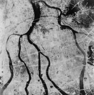 Aerial view of Hiroshima after the atomic bombing of August 6, 1945. The city was located on a flat river delta, with few obstructions to the contain the blast of the nuclear explosion detonated about the city on August 6, 1945. World War 2. (BSLOC_2014_10_125)