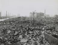 Hiroshima ruins were documented by U.S. Navy photographer Stanley Troutman on Sept. 7, 1945. In this photo, Troutman is standing in left foreground. World War 2. (BSLOC_2014_10_124)